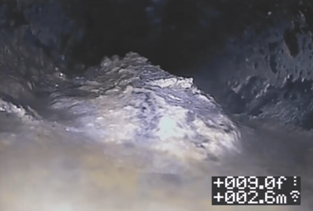 First image: Orangeburg warping identified through video pipe inspection.