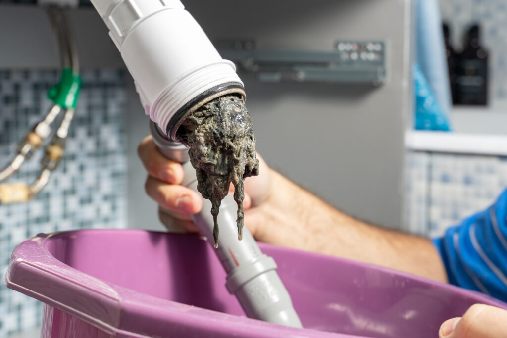 A blockage being removed from a previously clogged pipe