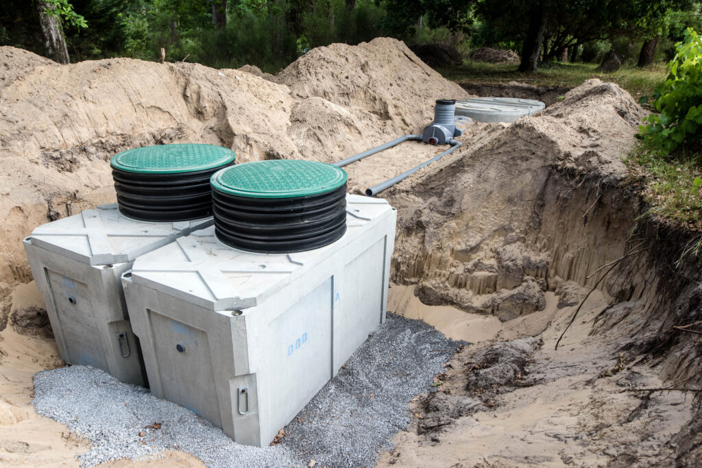 Two holding tanks that are being installed in a field