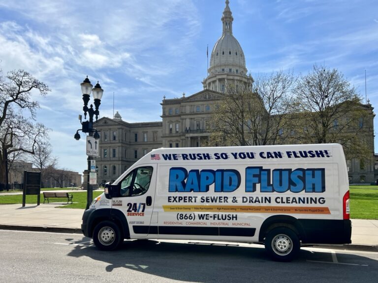 The Rapid Flush drain cleaning van outside of the capital building in Michigan.