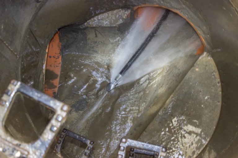 A high pressure water jet cleaning a sewer line.
