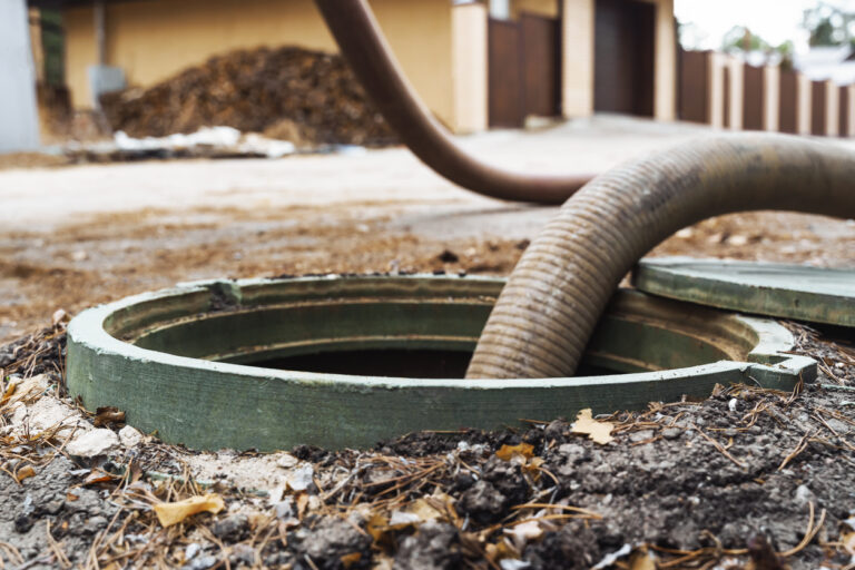 A cleaning pipe pumping out waste from a septic tank.