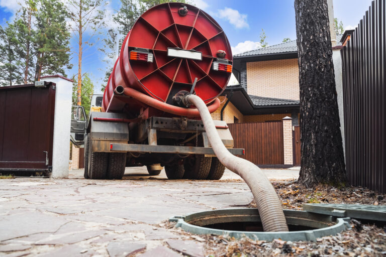 View of a septic truck pumping out sewage from a septic tank.
