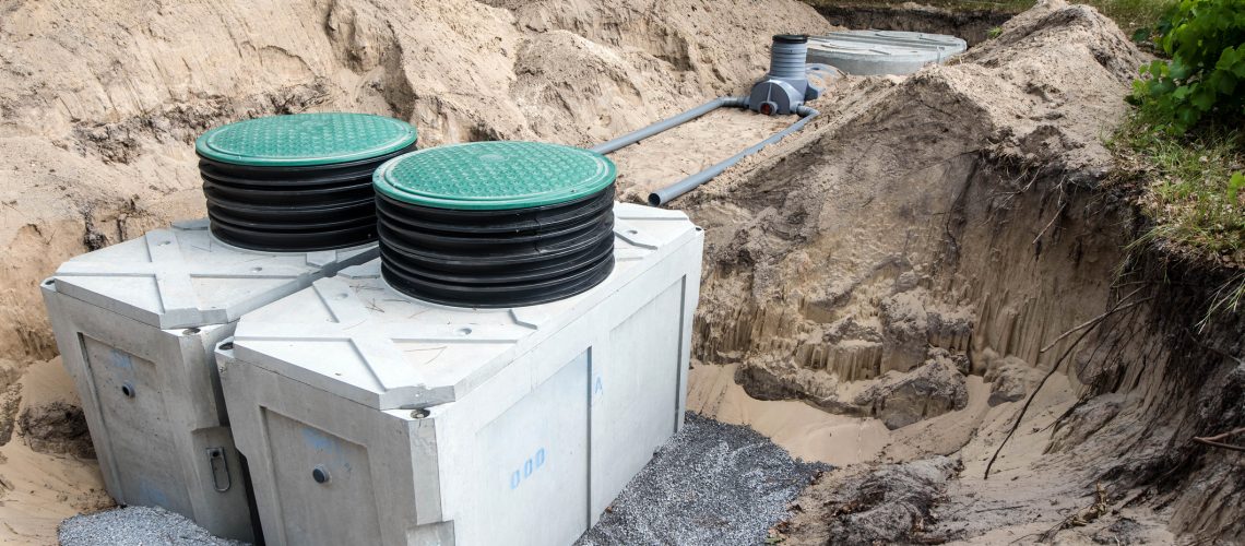 Two holding tanks that are being installed in a field